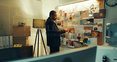 Buy stock photo Detective, man and board with info of evidence for case, investigation and criminal lead at police station. Mature African investigator, problem solving and point at mindmap for suspect at night