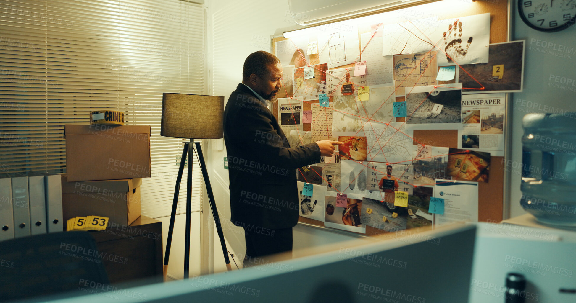 Buy stock photo Detective, man and board with info of evidence for case, investigation and criminal lead at police station. Mature African investigator, problem solving and point at mindmap for suspect at night