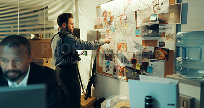 Buy stock photo Detective, man and board with documents of evidence for case, investigation and criminal lead at police station. Investigator, problem solving and point with tablet for  mindmap with suspect at night