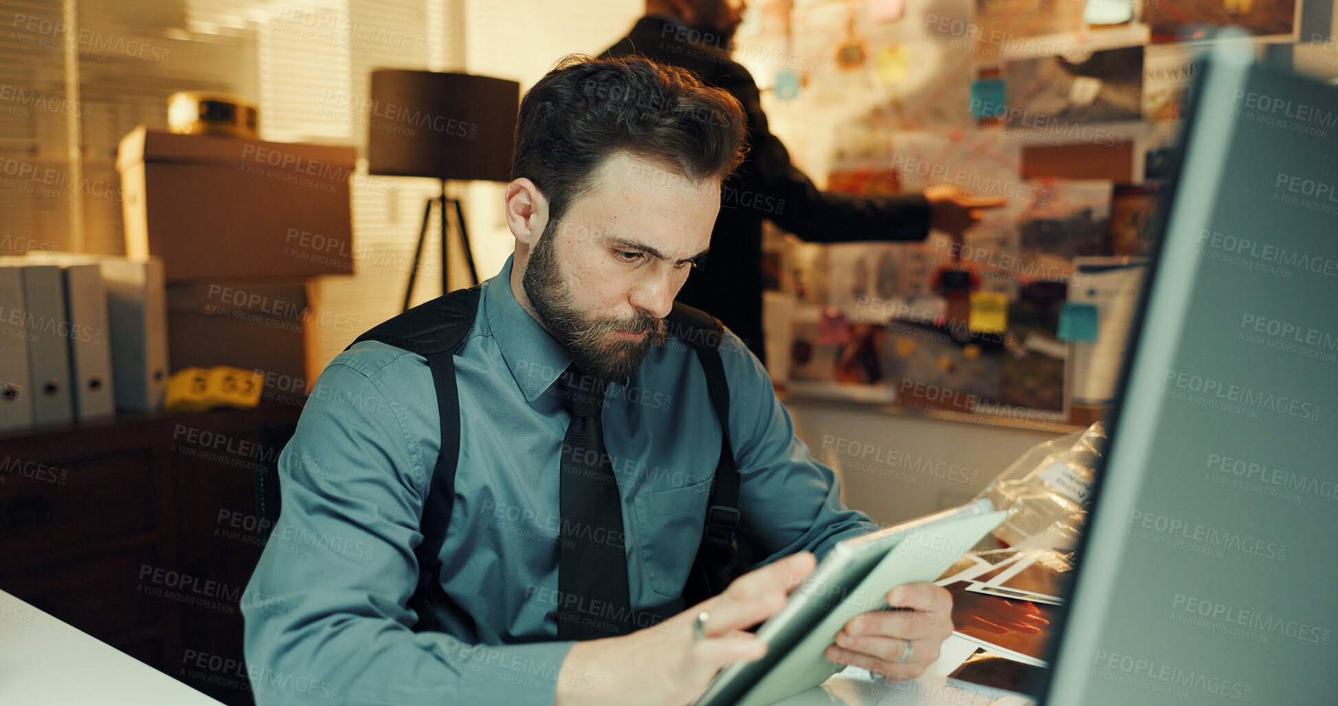 Buy stock photo Man, detective or research on tablet in office for arrest warrant, evidence report or online records. Night, people and tech for digital forensics, criminal database and crime investigation deadline