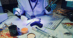 Hands, forensic analysis and scientist with gun, uv light and brush for fingerprint evidence. Police examination, murder weapon and firearm inspection or person dust knife for proof in laboratory