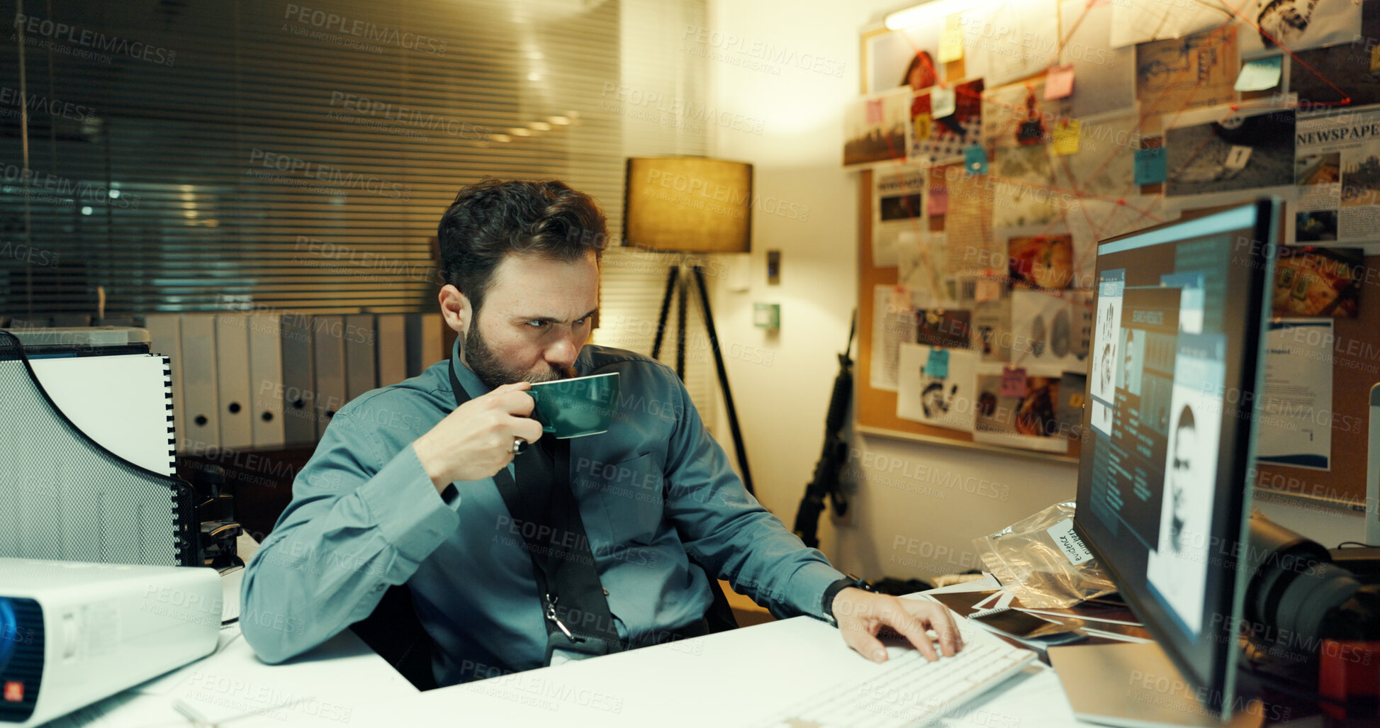 Buy stock photo Coffee, computer screen and investigation with police man in office at night for case or justice. Drink, evidence and thinking with detective at desk in workplace for review of crime search clues