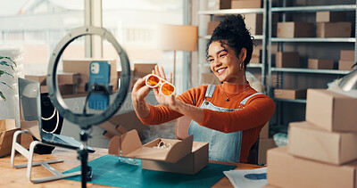 Buy stock photo Logistics, phone recording and sunglasses with woman in office for advertising or product review. Boxes, ring light and supply chain with happy employee at desk for delivery, distribution or storage