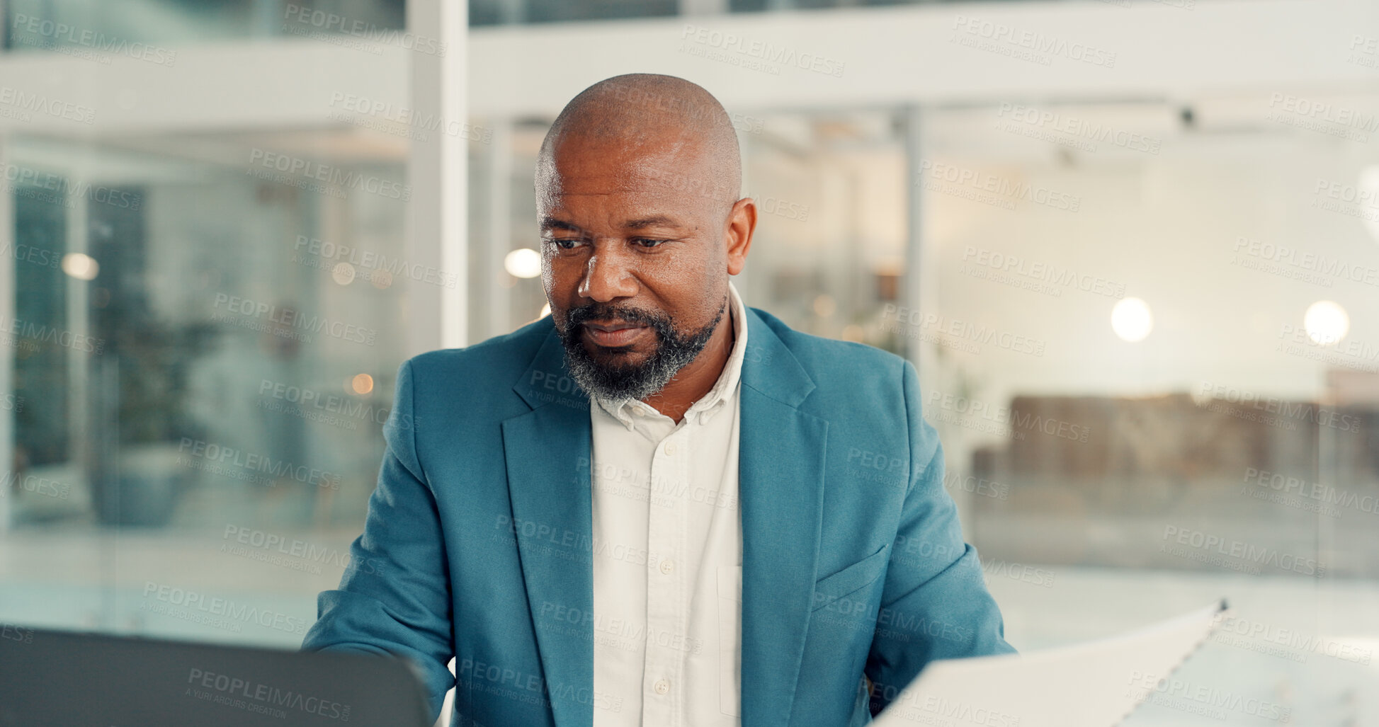 Buy stock photo Documents, laptop and reading with business black man in office for management of company development. Computer, paperwork and research with mature employee in corporate workplace for administration