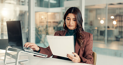 Buy stock photo Woman, documents and reading with laptop in office for company finance, budget planning or report. Female person, accountant or analyst with paperwork on computer for financial expenses in workplace