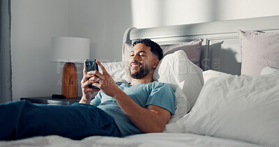 Buy stock photo Happy man, phone and relax in bed for communication, social media or reading ebook on weekend at home. Person, mobile app with text message or blog, email and contact with connectivity on day off