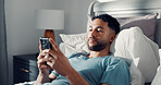Man, phone and relax in bed for communication, social media or reading ebook on weekend at home. Male person, mobile app with text message or blog, email and contact with connectivity on day off