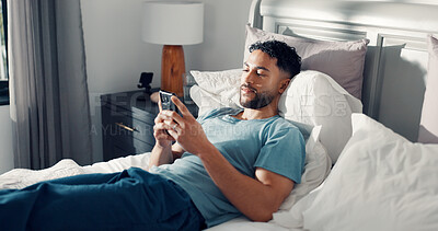 Buy stock photo Man, smartphone and relax in bed for communication, social media or reading ebook on weekend at home. Male person, mobile app with text message or blog, email and contact with connectivity on day off