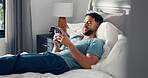 Man, phone and relax in bedroom for communication, social media or reading ebook on weekend at home. Male person, mobile app with text message or blog, email and contact with connectivity on day off