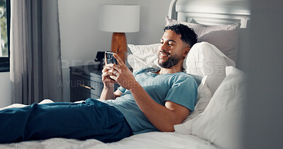 Buy stock photo Man, phone and relax in bedroom for communication, social media or reading ebook on weekend at home. Male person, mobile app with text message or blog, email and contact with connectivity on day off