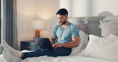 Buy stock photo Online, typing and man with laptop, bedroom and proofreading fiction story, website and remote work. Freelance, ghostwriter and person with tech for novel, creative or editing ebook on bed in house