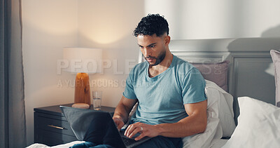 Buy stock photo Online, remote work and man with laptop, bedroom and proofreading fiction story, typing and website. Freelance, ghostwriter and person with tech for novel, creative or editing ebook on bed in house