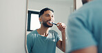 Mirror, brushing and teeth with man in bathroom for hygiene, oral health and bad breath prevention. Male person, reflection and toothbrush for dental care, remove plaque and cleaning mouth at house