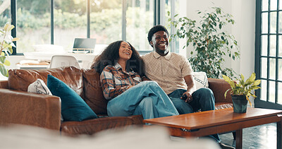 Buy stock photo Couple, home and watching TV with laugh, sofa and relax in living room for streaming subscription. Man, woman and happy for comedy movie, funny show or comfort in house with connection and remote