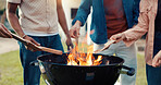 Hands, people and grill for bbq outdoor to start fire, new years party and social gathering. Friends, wood and prepare barbecue of lunch reunion, setup flame and bonding activity in backyard at house