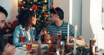 People, friends and talk with lunch for Christmas holiday with festive food, celebration and tradition. Man, woman and chat and event of social gathering, buffet reunion and bonding together at house