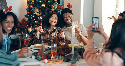 Buy stock photo Cheers, champaign and friends with phone for christmas celebration, festive reunion and social media post. Holiday, people and photography for bonding with xmas, profile picture and memory at house