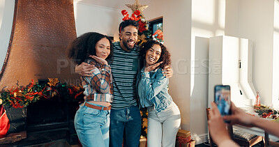 Buy stock photo Christmas, hug and photograph with group of friends in living room of home for festive celebration. Bonding, holidays and people embracing in apartment for memories, profile picture or social media