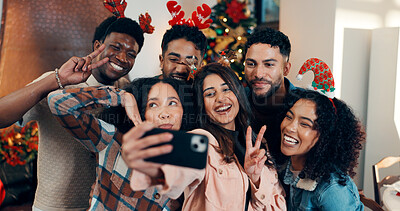 Buy stock photo Peace sign, group and friends with selfie for christmas celebration, festive reunion and social media post. Holiday, people and photography for bonding with xmas, profile picture and memory at house
