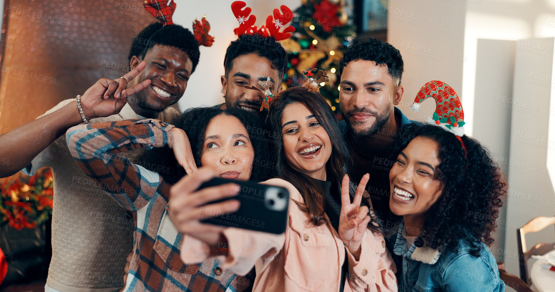 Buy stock photo Peace sign, group and friends with selfie for christmas celebration, festive reunion and social media post. Holiday, people and photography for bonding with xmas, profile picture and memory at house