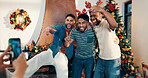 Excited, group and friends with phone for christmas celebration, festive reunion and social media post. Holiday, people and photography for bonding with xmas, profile picture and memory at house