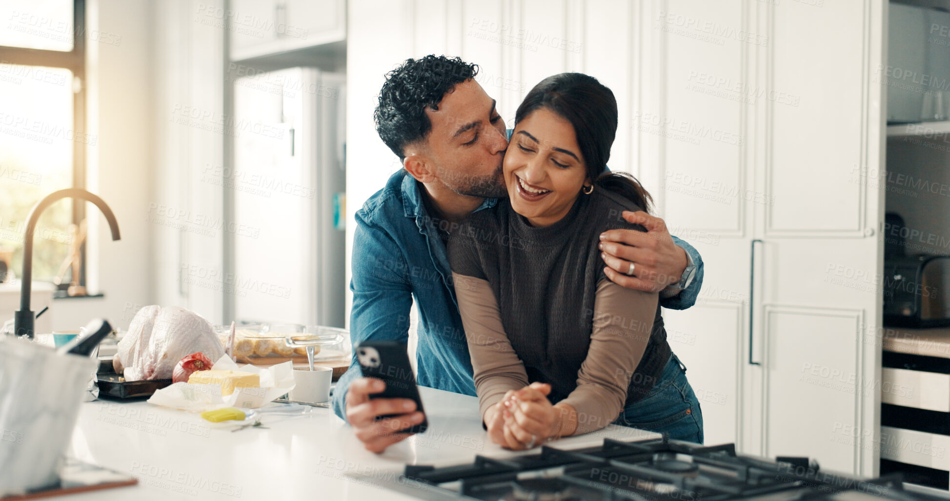 Buy stock photo Kissing, smartphone and couple in kitchen, love and bonding together with social media. Home, cellphone and man with woman, embrace and relationship with internet, romance and marriage with app