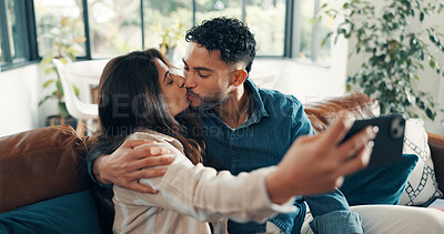 Buy stock photo Selfie, kissing and couple on sofa, love and bonding together with happiness, memory and marriage. Home, profile picture and man on couch, woman or relax with relationship, romance or photography