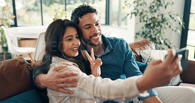 Buy stock photo Selfie, peace sign and couple on sofa, smile and bonding together with embrace, memory and marriage. Home, profile picture and man with woman, happiness and relax with relationship and romance