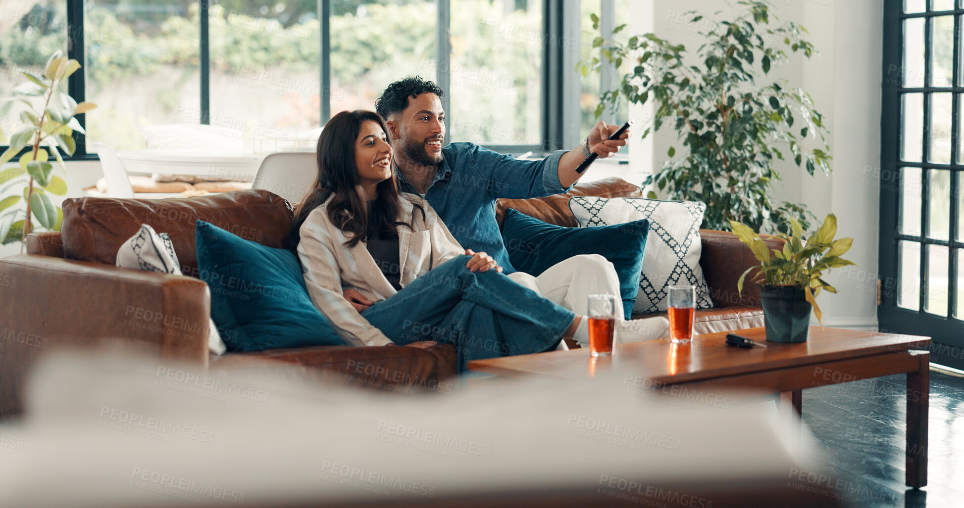 Buy stock photo Relax, sofa and couple watching tv in home for bonding, connection or date together on weekend. Happy, remote and man with woman in living room for streaming movie, film or show in apartment.
