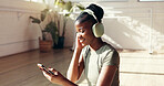 Yoga, phone and black woman with headphones for music for workout playlist, exercise or social media. Morning, happy and person listen to audio, radio and online for wellness, health app and pilates