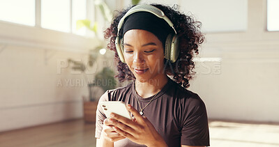 Buy stock photo Yoga, phone and woman with headphones for music for workout playlist, exercise or social media. Morning, happy studio and person listen to audio, radio and online for wellness, health app and pilates