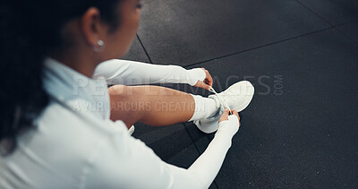 Buy stock photo Sneakers, fitness and woman tying laces in gym for workout, safety or training for wellness. Shoes, athlete and top view of person getting ready for exercise, health or cardio in sports center.