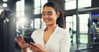 Buy stock photo Texting, athlete and woman with smartphone, gym or communication with contact on social media or web. Fitness, chat and person with mobile on break, happy and typing message with tech in health club
