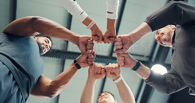 Buy stock photo Below, circle and hands of people with fitness team, partner or solidarity with huddle for support in gym. Group, fist bump and trust in exercise community, synergy and connection for health together