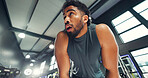 Tired, workout and man in gym, sweating and wellness with fatigue, training and challenge. Exercise, health center and person with fitness, break and exhausted with commitment, rest and endurance