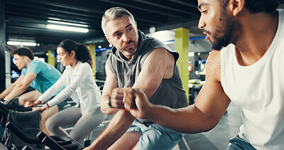 Buy stock photo Fitness, men and fist bump on stationary bike at gym for cardio challenge, training and support. Athlete, people and celebration in spin class for cycling progress, teamwork and exercise performance