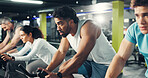 Spin class, group and man in gym on bicycle for exercise, cardio workout and intense training. Sports, cycling and men  with woman on stationary bike for endurance challenge, health and wellness