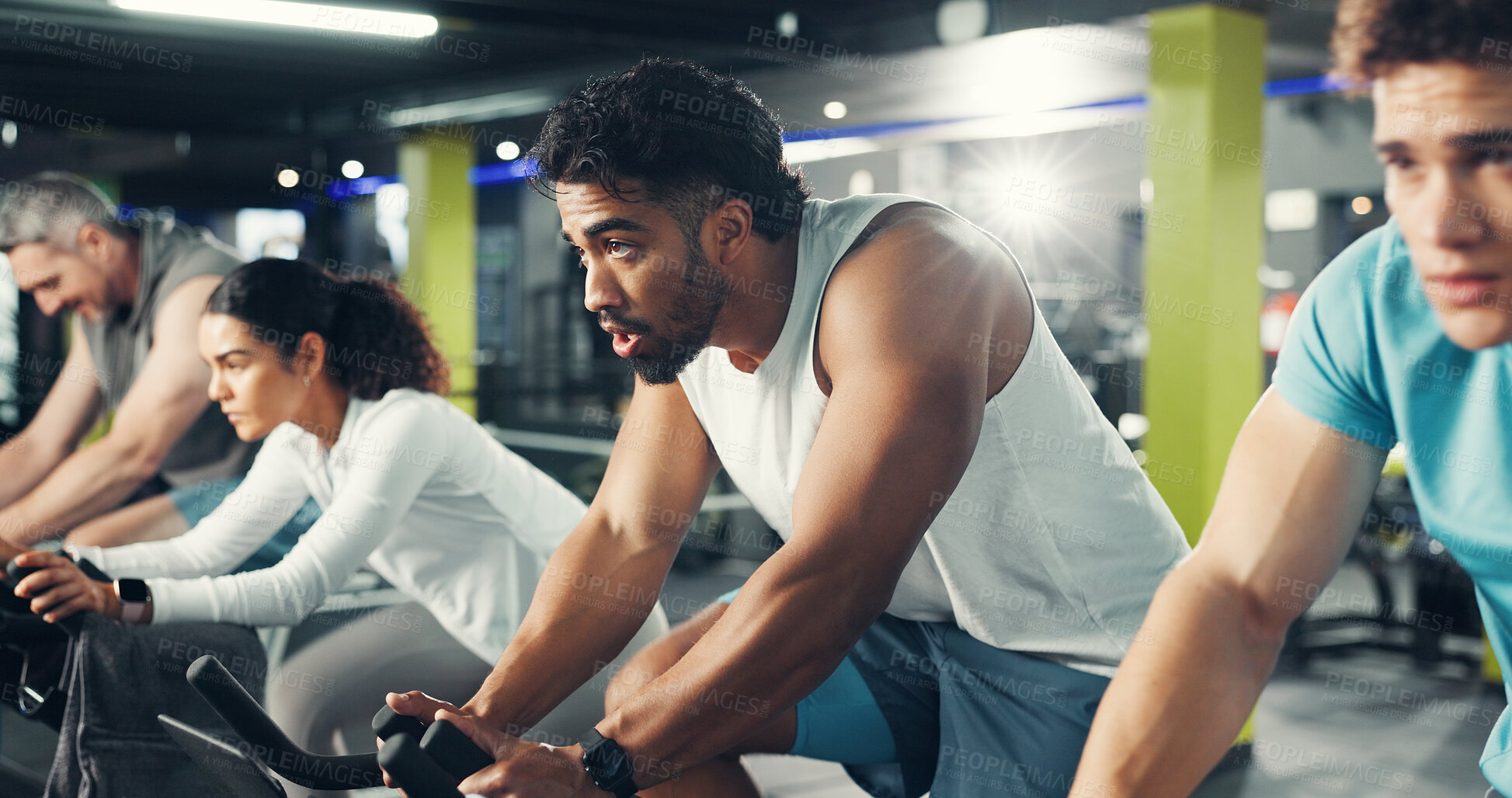 Buy stock photo Spin class, group and man in gym on bicycle for exercise, cardio workout and intense training. Sports, cycling and men  with woman on stationary bike for endurance challenge, health and wellness