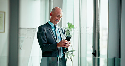 Buy stock photo Business, phone and window with mature man in office for break, text message or update. App, contact and typing on mobile with corporate employee in workplace for communication, planning or research