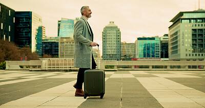 Businessman, walking and city with suitcase for travel, commute or career opportunity. Mature, man or traveler with luggage in an urban town for corporate journey, business trip or start of new job