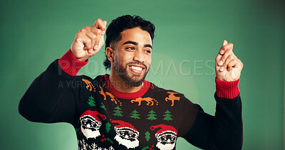 Buy stock photo Christmas, smile and man dance in studio for celebration at festive event on green background. Xmas, happiness and person moving with rhythm, winter holiday and energy for party music with tradition