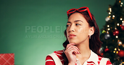 Buy stock photo Thinking, Christmas and woman in studio with space for tradition, celebration or holiday with ideas. Planning, decision and female person by xmas tree for choice at festive event on green background.