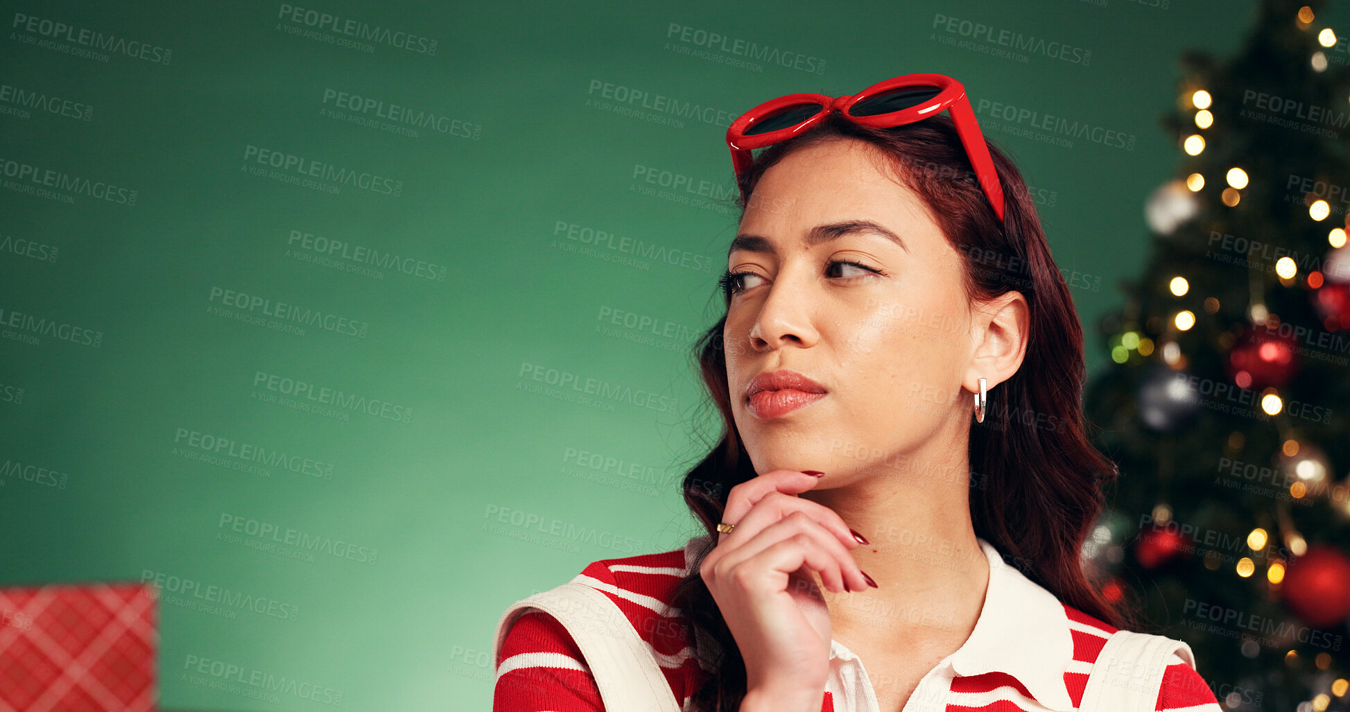 Buy stock photo Thinking, Christmas and woman in studio with space for tradition, celebration or holiday with ideas. Planning, decision and female person by xmas tree for choice at festive event on green background.