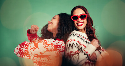 Buy stock photo Christmas, friends and women dance in studio for celebration at festive event on green background. Xmas season, happiness and girls moving with rhythm for holiday, energy and party music with bokeh