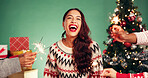 Christmas, hands and excited woman with sparkler in studio for festive season on green background. Happy girl, xmas and firework for holiday celebration, funny portrait or laugh at party with friends