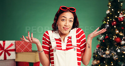 Buy stock photo Christmas, decision and confused with portrait of woman in studio for choice, wish list or holiday season. Option, festive gift idea and xmas with person on green background for why and present