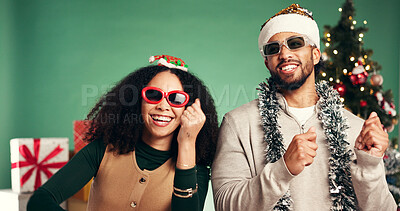 Buy stock photo Happy, people and dancing in studio for Christmas holiday, xmas party and celebration. Smile, friends and sunglasses with performance, moving rhythm and energy for festive season on green background