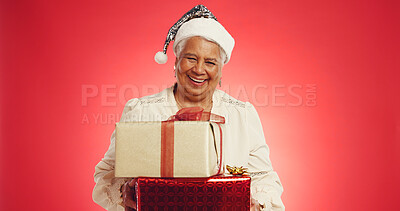 Buy stock photo Christmas, elderly woman or boxes in studio with portrait, happy or giveaway gifts in retirement. Old person, excited or present on red background space for festive season, Xmas tradition or surprise