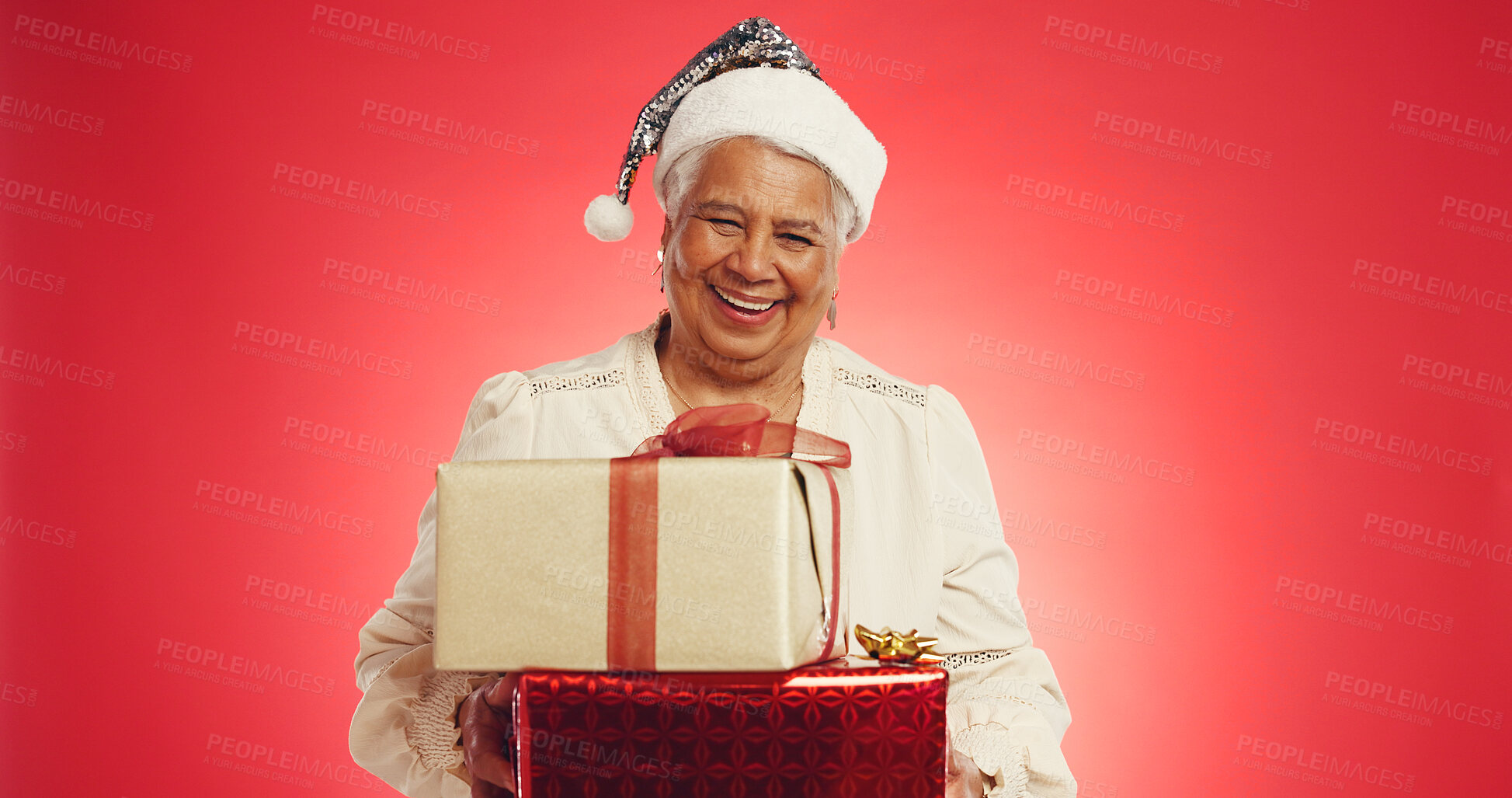 Buy stock photo Christmas, elderly woman or boxes in studio with portrait, happy or giveaway gifts in retirement. Old person, excited or present on red background space for festive season, Xmas tradition or surprise