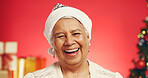 Happy, christmas and portrait of senior woman in studio with decorations for festive tradition. Smile, santa hat and elderly female person from Mexico with pride for xmas holiday by red background.